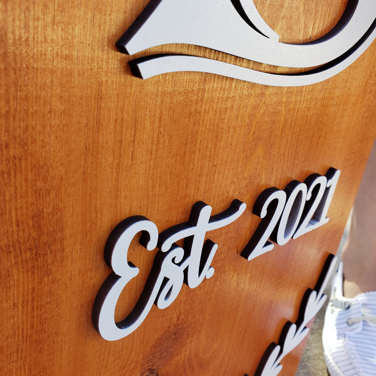 Close-up of raised 3D lettering on a personalized family porch sign